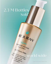 Load image into Gallery viewer, A bottle of REJURAN healer Turnover Ampoule Dual Effect skincare, shown at an angle against a light teal gradient background with promotional text overlays.